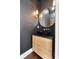 Modern powder room with a unique round mirror, vessel sink, and elegant fixtures at 4310 Ethan Lane Ln, Orlando, FL 32814