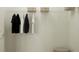 A simple closet featuring hanging racks and shelf for storage at 4541 Ochos Rios Pl, Kissimmee, FL 34758
