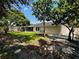 Exterior shot revealing the home with its screened patio and expansive backyard space at 4800 Reginald Rd, Orlando, FL 32829