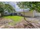 View of the home's exterior featuring a screened-in patio and a generously sized backyard at 4800 Reginald Rd, Orlando, FL 32829