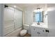 Bathroom featuring a shower-tub combo, tile surround, a toilet, and a vanity with modern lighting at 4800 Reginald Rd, Orlando, FL 32829