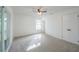 Spacious bedroom features neutral carpet, a ceiling fan, and ample natural light from a window at 4800 Reginald Rd, Orlando, FL 32829