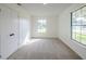 Bedroom showcasing neutral carpet, two windows allowing natural light, and a closet at 4800 Reginald Rd, Orlando, FL 32829