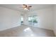 Spacious bedroom featuring neutral carpet, a ceiling fan, and sliding door access to the outdoors at 4800 Reginald Rd, Orlando, FL 32829