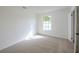 Bright bedroom with neutral carpet, a window providing natural light, and a closet for storage at 4800 Reginald Rd, Orlando, FL 32829