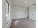 Bedroom featuring neutral carpet, a window, closet, and a view to the hall at 4800 Reginald Rd, Orlando, FL 32829