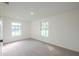 Bright bedroom featuring neutral carpet, two windows for natural light, and an open layout at 4800 Reginald Rd, Orlando, FL 32829