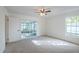 Bright bedroom featuring neutral carpet, a ceiling fan, and sliding door access to the outdoors at 4800 Reginald Rd, Orlando, FL 32829