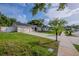Charming home with well-maintained lawn, paved driveway, and attached two-car garage at 4800 Reginald Rd, Orlando, FL 32829