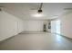 Spacious garage with modern door, painted floor, and access to utilities and living space at 4800 Reginald Rd, Orlando, FL 32829