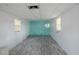 This room features wood-look flooring, a textured accent wall, and natural light from two windows at 4800 Reginald Rd, Orlando, FL 32829