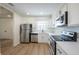 Updated kitchen featuring stainless steel appliances, white cabinets, and a window over the sink at 4800 Reginald Rd, Orlando, FL 32829