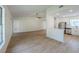Bright living room with views into the kitchen and light wood flooring throughout at 4800 Reginald Rd, Orlando, FL 32829