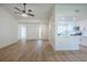 Bright living room featuring wood floors, neutral paint, a ceiling fan and views to the kitchen at 4800 Reginald Rd, Orlando, FL 32829