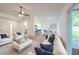 Bright, open living room features light hardwood floors, modern ceiling fan, and neutral decor at 4800 Reginald Rd, Orlando, FL 32829