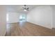 Open living room with light wood flooring, vaulted ceiling, a ceiling fan and natural light at 4800 Reginald Rd, Orlando, FL 32829