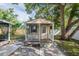 Charming outbuilding with screened porch and a solid, lockable front door at 4800 Reginald Rd, Orlando, FL 32829
