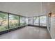 Enclosed patio offering an outdoor living space with screened walls, ceramic tile flooring, and outdoor views at 4800 Reginald Rd, Orlando, FL 32829