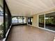A screened in patio with neutral tile flooring and open views of the surrounding yard at 4800 Reginald Rd, Orlando, FL 32829