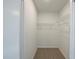 Spacious walk-in closet featuring wire shelving and neutral carpeting for organized storage solutions at 4800 Reginald Rd, Orlando, FL 32829