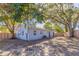Backyard featuring mature trees and the back of the house with privacy fence at 4933 Balboa Dr, Orlando, FL 32808