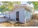 View of the backyard with brown privacy fence and an exterior view of the home at 4933 Balboa Dr, Orlando, FL 32808