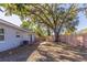 Backyard featuring a wooden fence, concrete patio and shady trees at 4933 Balboa Dr, Orlando, FL 32808