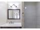A modern bathroom features a large mirror, updated fixtures, and a tiled shower at 4933 Balboa Dr, Orlando, FL 32808