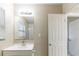 Bathroom with a white vanity, mirrored cabinet, and natural light from a window at 4933 Balboa Dr, Orlando, FL 32808
