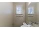 Half bath features a vanity, large mirror, and window allowing natural light at 4933 Balboa Dr, Orlando, FL 32808