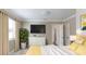Bright bedroom featuring a flat-screen TV, modern dresser, and stylish decor at 4933 Balboa Dr, Orlando, FL 32808