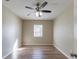 A spacious bedroom features wood-look floors, a ceiling fan, and a window at 4933 Balboa Dr, Orlando, FL 32808
