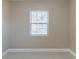 An empty bedroom with white tile flooring and baseboards has a bright and modern appeal at 4933 Balboa Dr, Orlando, FL 32808