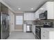Modern kitchen with stainless steel appliances, stylish backsplash, and bright lighting at 4933 Balboa Dr, Orlando, FL 32808