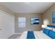 Comfortable main bedroom with a large bed, blue accents, and a closet for storage at 4933 Balboa Dr, Orlando, FL 32808