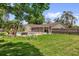 Spacious backyard with a pool, covered patio, and mature landscaping at 4959 Ardmore Dr, Winter Park, FL 32792