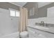 Bright bathroom featuring white decor, a bathtub, and a sink with marble countertops at 4959 Ardmore Dr, Winter Park, FL 32792