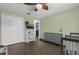 Cozy bedroom featuring hardwood floors, gray decor, and two cribs at 4959 Ardmore Dr, Winter Park, FL 32792