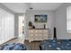 Bedroom featuring two twin beds, gray decor, hardwood floors, and a dresser at 4959 Ardmore Dr, Winter Park, FL 32792