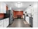 Bright kitchen with white cabinets, stainless steel appliances, and a view to the dining area at 4959 Ardmore Dr, Winter Park, FL 32792