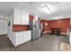 Updated kitchen featuring white cabinets, stainless steel appliances, and black countertops at 4959 Ardmore Dr, Winter Park, FL 32792