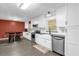 Well-lit kitchen with white cabinets, stainless steel appliances, and a cozy dining nook at 4959 Ardmore Dr, Winter Park, FL 32792