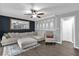 Spacious living room featuring a large sectional sofa and a decorative mirror at 4959 Ardmore Dr, Winter Park, FL 32792