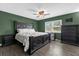 Relaxing main bedroom featuring dark wood furniture, hardwood floors, and a large window at 4959 Ardmore Dr, Winter Park, FL 32792