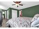 Comfortable main bedroom boasting a ceiling fan, hardwood floors, and plenty of closet space at 4959 Ardmore Dr, Winter Park, FL 32792