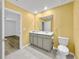 Bright bathroom features a double sink vanity, a toilet, and tile flooring that adds a modern touch to the space at 584 S Andrea Cir, Haines City, FL 33844