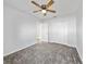Bedroom featuring neutral gray carpet, white walls, closet and a door that leads to another room at 584 S Andrea Cir, Haines City, FL 33844