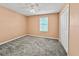 Carpeted bedroom with a ceiling fan, window with blinds and a closet at 584 S Andrea Cir, Haines City, FL 33844