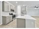 Kitchen featuring white countertops, stainless steel appliances, grey cabinets and breakfast bar at 584 S Andrea Cir, Haines City, FL 33844