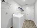 Laundry room with a washer, dryer, and shelving for efficient organization and convenience at 584 S Andrea Cir, Haines City, FL 33844